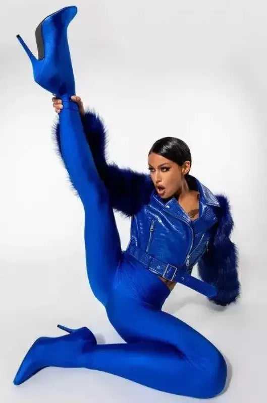 Woman wearing stylish in blue stiletto pant boots showcasing the fashionable stiletto pant boots