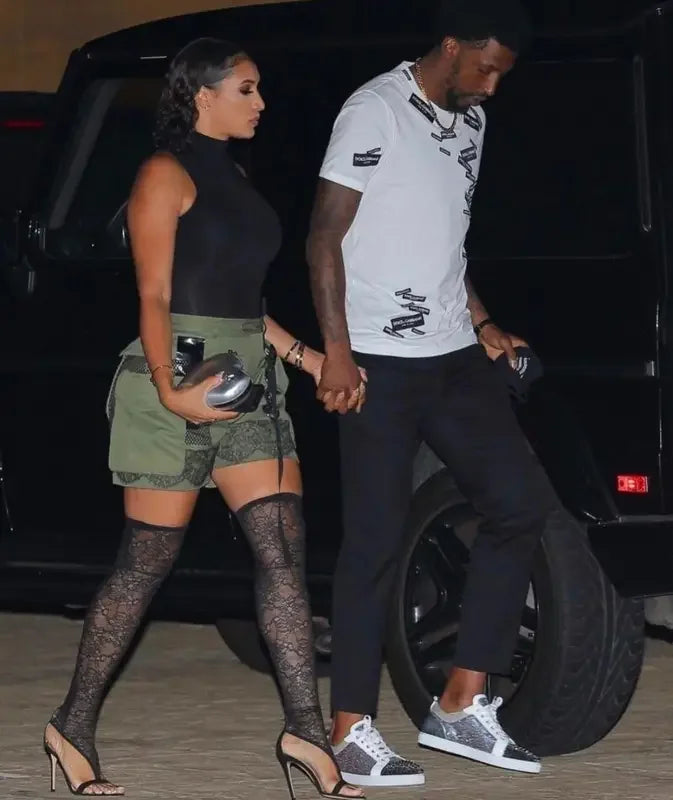 Image of a couple holding hands wearing stylish knee lace gladiator boots