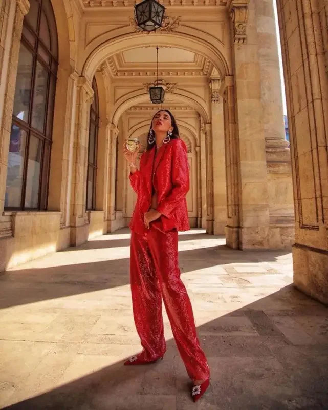 Woman wearing a fashion sequin blazer and straight trousers in red sequined suit