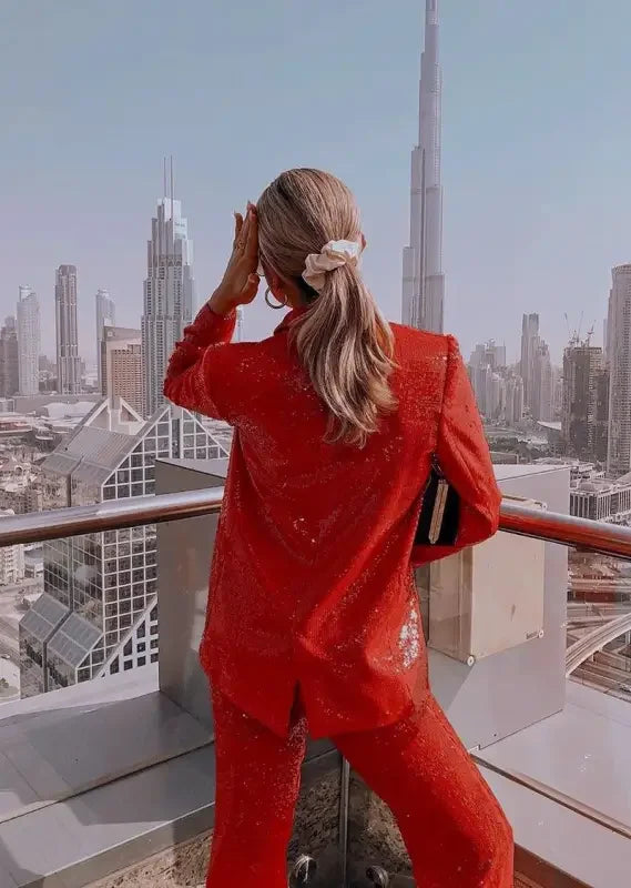 Woman in a red fashion sequin blazer and straight trousers appearance