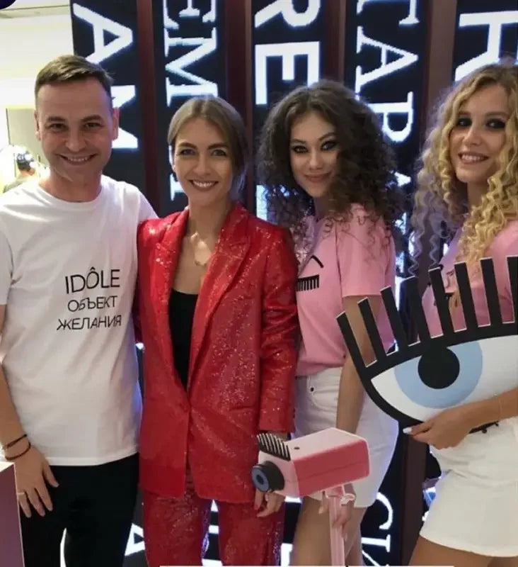Group of people posing in stylish fashion sequin blazer and straight trousers ensemble