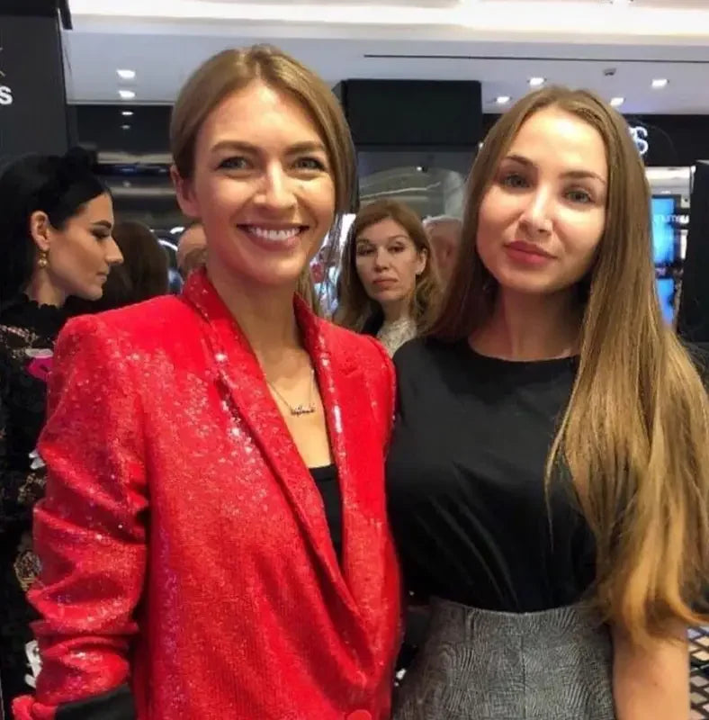 Two women posing in fashion sequin blazer and straight trousers for a stylish look