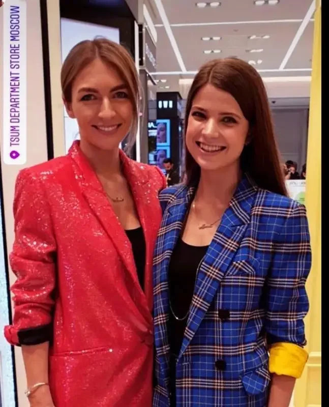 Two women wearing stylish fashion sequin blazers and straight trousers in a fashion look