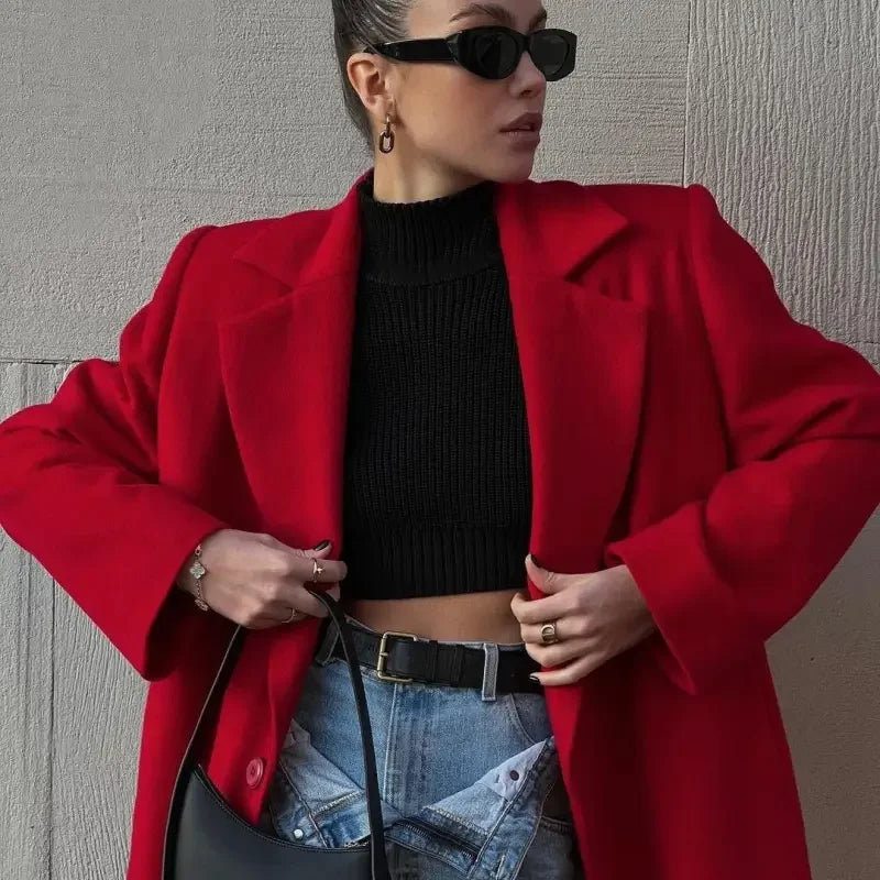 Woman in a dark red woolen women coat paired with black top and jeans