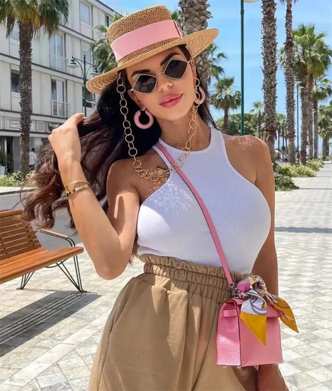 Stylish woman wearing pink accessories and Rhombus sunglasses from an online boutique
