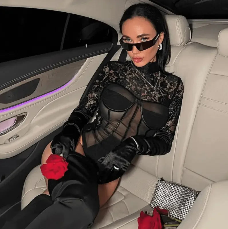 Woman wearing a long sleeve lace black bodysuit showcasing elegant sleeve lace black design