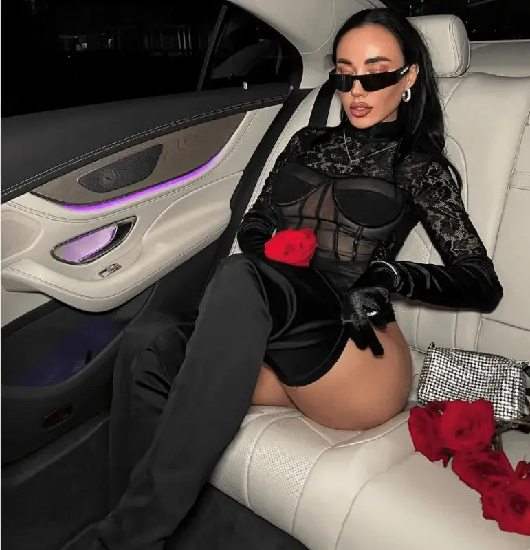 Woman in a black long sleeve lace bodysuit with roses for an elegant fashion look