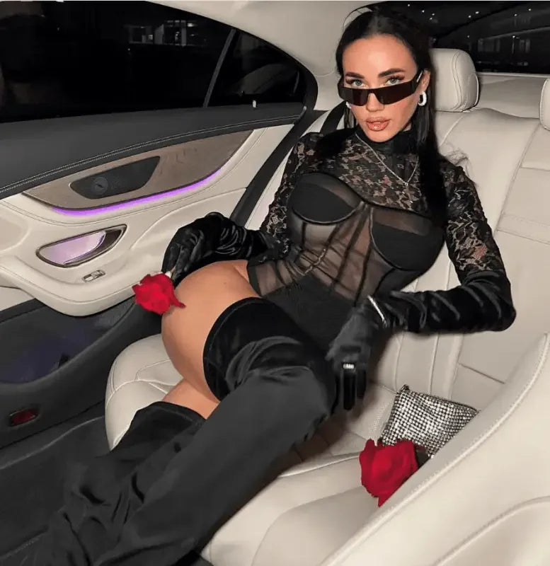 Woman wearing a long sleeve lace black bodysuit with thigh-high boots for style and elegance