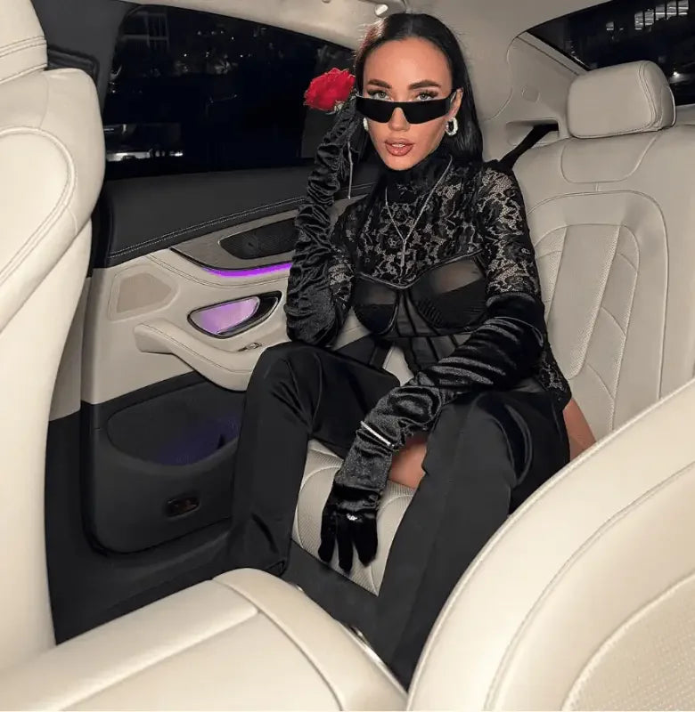 Woman wearing a long sleeve lace black bodysuit demonstrating elegant style