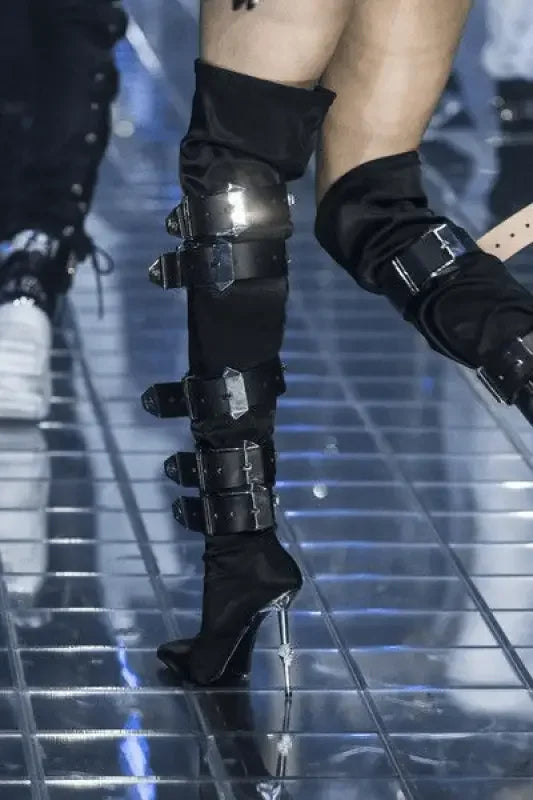 Black thigh-high belt embellished runway boots with buckle straps and high heels
