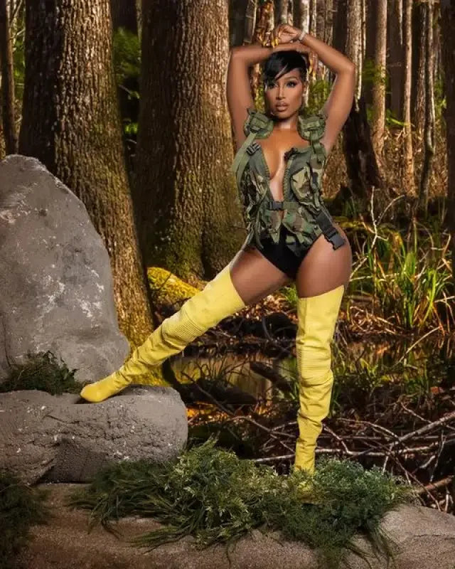 Woman in camouflage bodysuit wearing Catwalk Boots Spring long boots and yellow thigh-highs