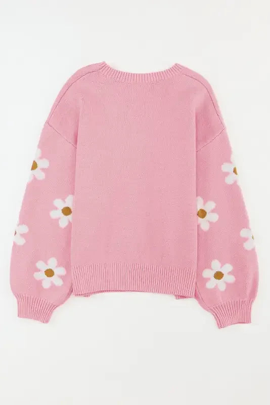 Pink knit sweater with daisy floral pattern and drop shoulder design by Sweater Fashionsarah