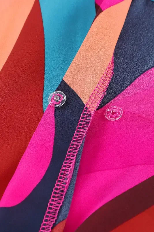 Colorful patterned belted puff sleeve mini dress with clear buttons and red abstract print