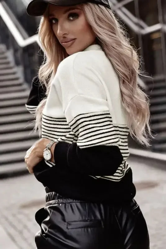 Black striped contrast colorblock knit top paired with leather pants displayed