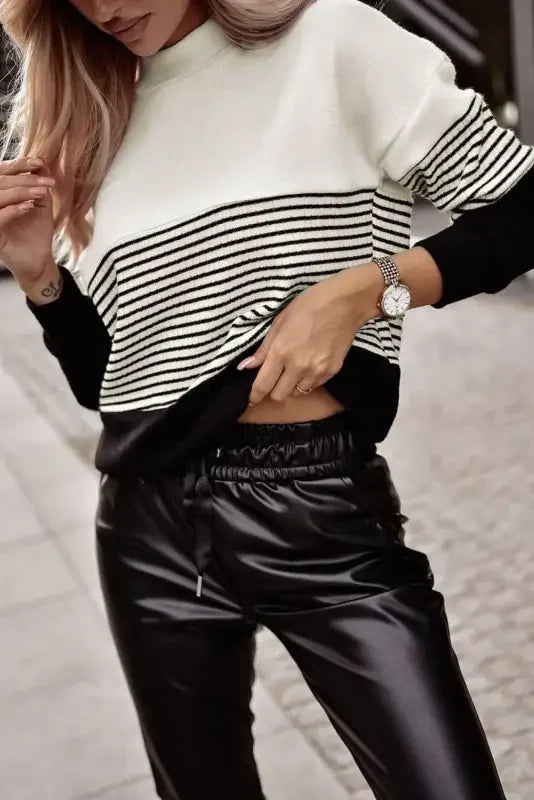 Black striped contrast colorblock knit top paired with black faux leather pants