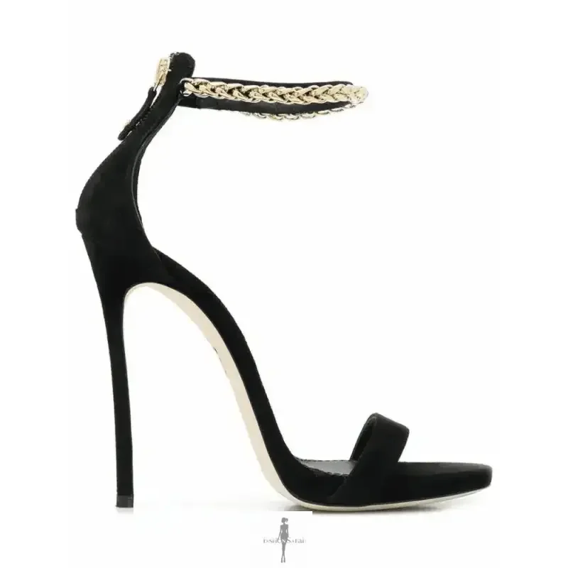 Elegant high heels featuring a black stiletto sandal with gold chain ankle strap