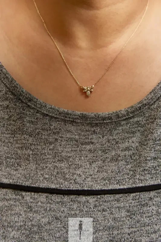 Gold necklace with a small pendant perfect for summer outfits and dresses in fashion