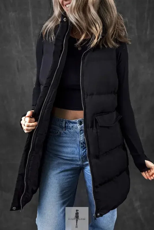 Woman wearing a long black windproof vest with pockets for stylish warmth