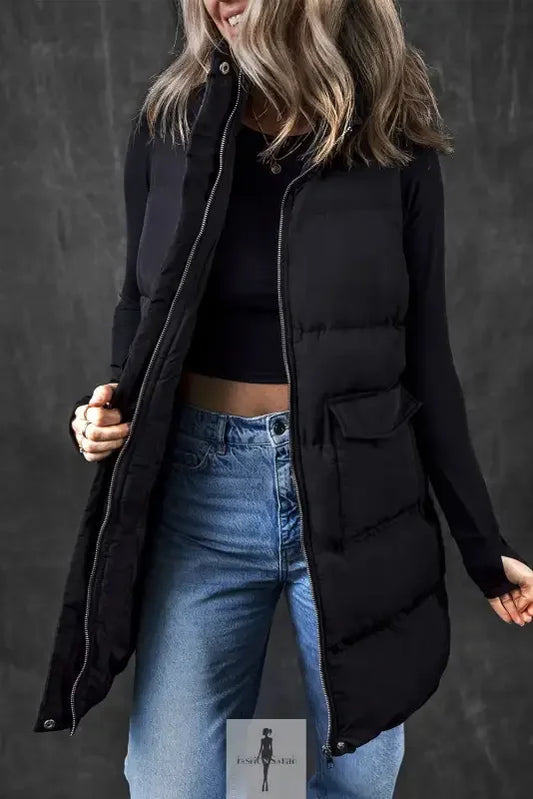 Woman wearing a long black windproof vest with pockets for stylish warmth