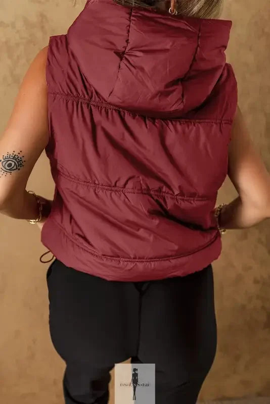 Burgundy hooded puffer vest with side pockets, ideal for stylish warmth and comfort