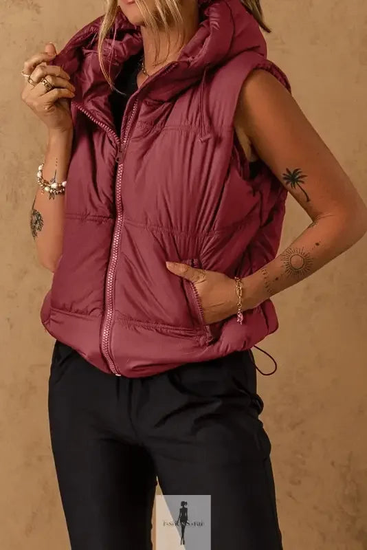 Burgundy hooded puffer vest with side pockets, ideal for stylish cold-weather wear