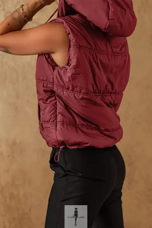 Burgundy hooded puffer vest with side pockets, perfect for stylish warmth
