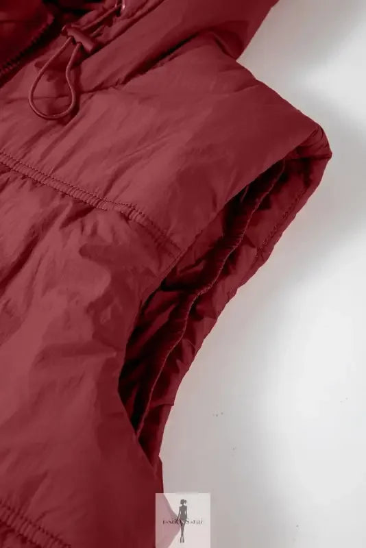 Maroon hooded puffer vest with side pockets, ideal for stylish cold-weather wear