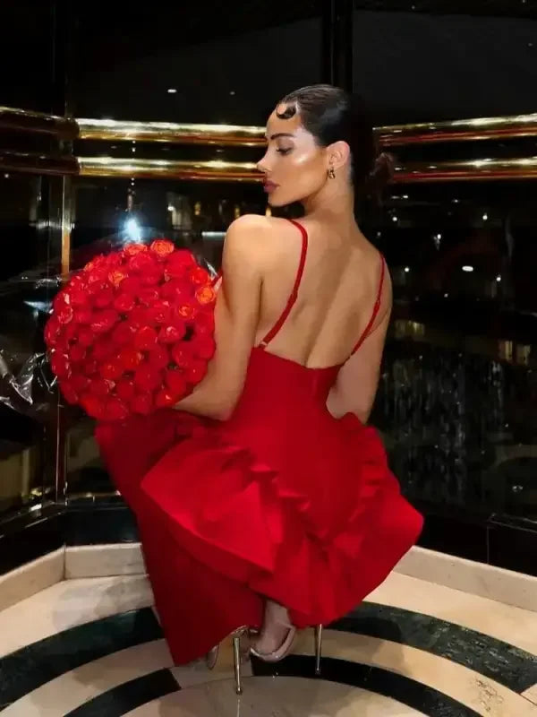 Woman in red ruffles bandage dress holding roses at an online boutique