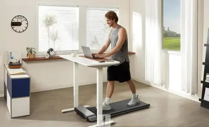 Man using a walkingpad foldable treadmill at a desk for active workout